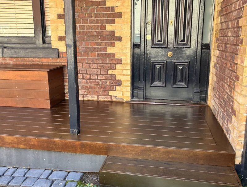New wooden porch and steps, carpentry work on a brick house.