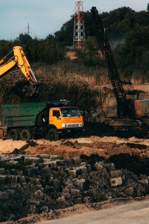 closeup-shot-ongoing-construction-with-tracks-bulldozer-abandoned-land_181624-32699